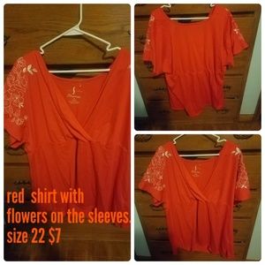 Red shirt with white flowers on sleeve